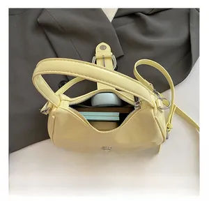 Interior view showing the large capacity and storage space of the yellow underarm bag