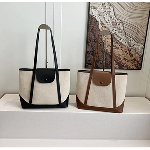 Détail de sacs cabas en toile avec bordure en cuir et poche à rabat magnétique, tons neutres