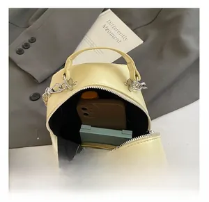 Internal view of cream quilted crossbody bag showing spacious storage for phone and makeup