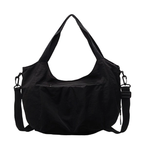 Minimalist black nylon crossbody tote bag with large zipper pocket and adjustable strap