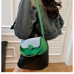 Détail du mini sac à bandoulière vert avec rabat tissé bleu et fermoir tournant doré