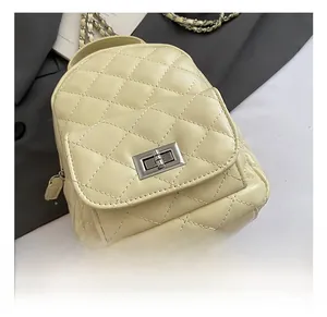 Detail shot of the silver metal turn-lock and quilted texture on a mini backpack