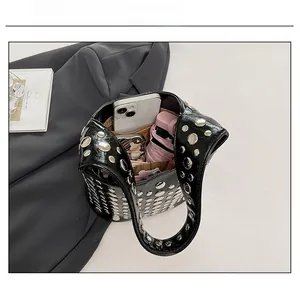 Top view of black studded bucket bag showing spacious interior with daily essentials