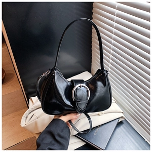 Detail of black PU leather crescent underarm bag with decorative silver metal ring