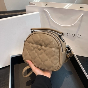 Chic quilted crossbody bag in beige leather with top handle and elegant gift packaging