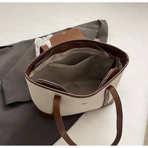 Détail du grand sac cabas en toile avec garniture en cuir marron et poche intérieure spacieuse