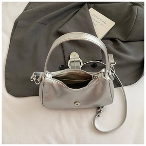 Detailed interior of a silver matte crossbody bag with zipper and metallic finish