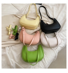 Flat lay of five smooth leather half-moon shoulder bags in pastel trendy colors