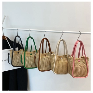 Collection of woven bucket bags in black green brown beige and pink with leather handles