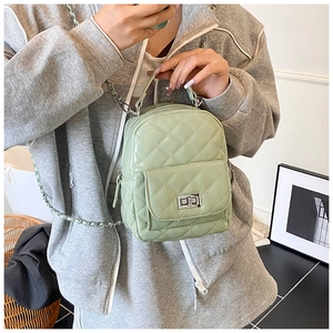 Close-up of mint green quilted PU leather backpack with silver chain straps and flap pocket