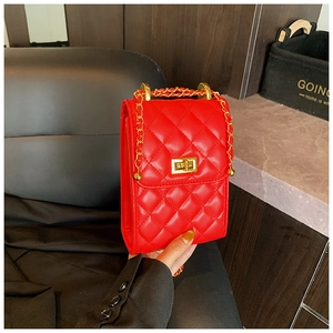 Detail of red quilted chain bag featuring a gold square twist lock and smooth PU leather