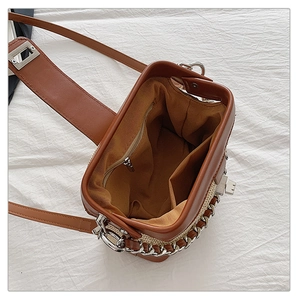 Detail view of the interior lining and zip pocket of this woven contrast crossbody bag