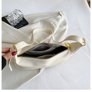 Interior view of off-white leather shoulder bag showing spacious lining and pockets