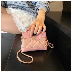 Close-up of pink quilted leather mini bag featuring a gold flower lock and chain strap
