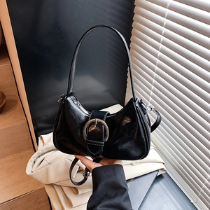 Classic black underarm bag with a large silver buckle and adjustable shoulder strap