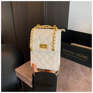 Detail of white quilted mini chain bag with gold twist lock and pearl orb accent