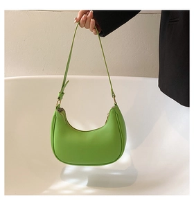 Detail of bright green hobo bag featuring adjustable strap and smooth leather texture