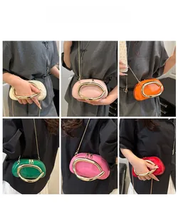 Detailed views of diverse patent leather handbags with golden C-ring handles and chain straps