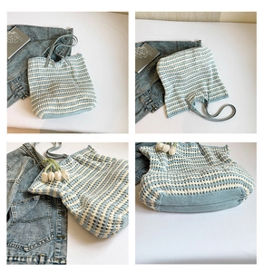 Close-up of blue and white striped hand-woven crochet tote bag with faux leather handle