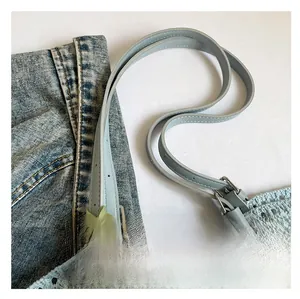 Close-up of comfortable light blue leather strap and hand-woven crochet bag texture