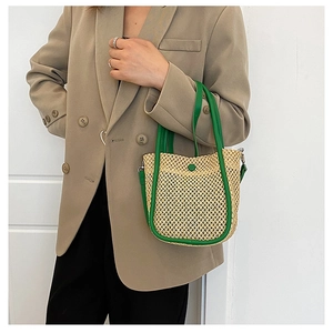 Detail of woven mesh texture and green leather trim on a stylish bucket bag
