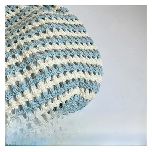 Macro detail of hand-woven striped beach bag with blue and white zigzag pattern