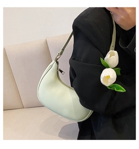 Chic light green hobo bag styled with black blazer and fresh white tulips