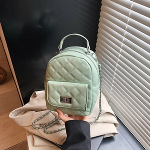 Mint green quilted mini backpack featuring silver twist lock and chain shoulder strap