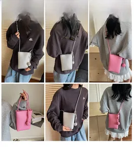 Detailed views of mini bucket cross-body bags in silver and pink with spherical knot detail
