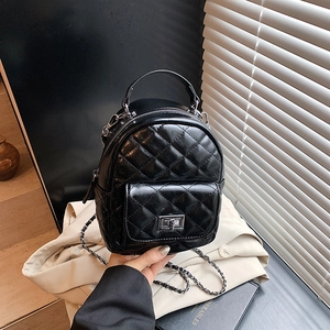 Classic black quilted leather mini backpack with silver chain straps and turn-lock detail
