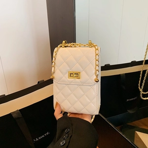 Quilted cream leather crossbody bag with gold chain strap and turn-lock closure