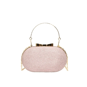 Pink glitter chain clutch bag with golden bow clasp and round handle for evening