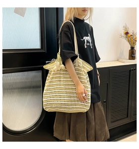 Close-up of hand-woven striped tote bag with 3D tulip charms and crochet texture