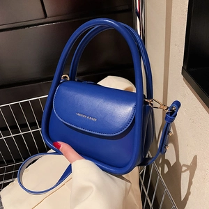 Royal blue matte leather handbag with gold lettering and detachable shoulder strap
