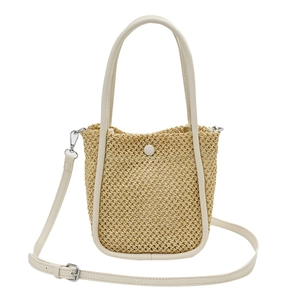 French style woven bucket bag in natural straw with creamy leather handles and strap