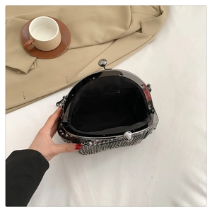 Detailansicht der schwarzen Abendtasche mit Innentasche und Fransen aus Metallketten