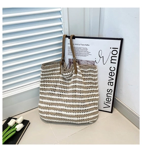 Close-up of striped woven tote bag featuring cotton crochet texture and brown leather straps