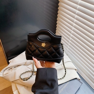 Quilted black leather mini handbag with gold camellia floral hardware and chain strap