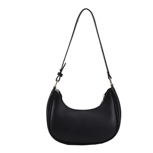 Minimalist black leather half-moon hobo bag with sleek gold hardware and zipper closure