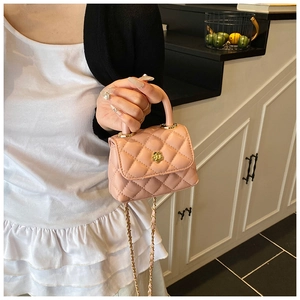 Detail of mini tweed handbag with quilted pattern and gold flower buckle for girls