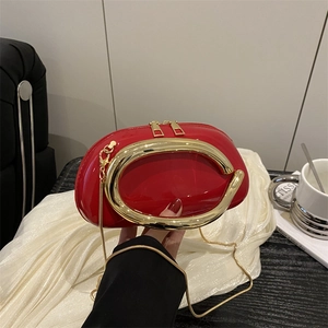 Glossy red patent leather evening clutch bag with round gold handle and chain strap
