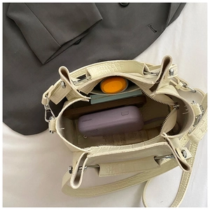 Internal view of beige crocodile embossed bucket bag showing large storage capacity
