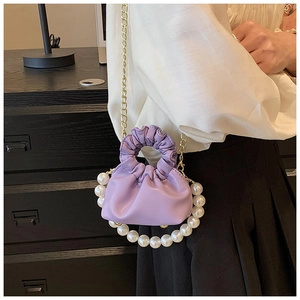 Detail of lavender mini cloud bag with pearl ring handle and gold chain strap