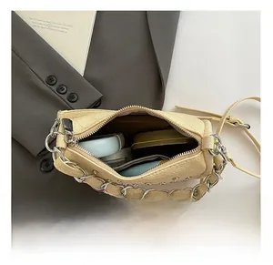 Interior view of the studded woven bag showing space for lipstick and makeup items