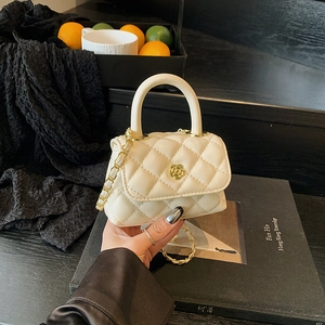 Mini cream quilted handbag for children with gold floral clasp and chain strap