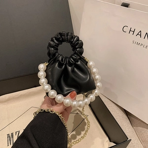 French style ruched dumpling bag in black leather with large pearl handle and chain strap