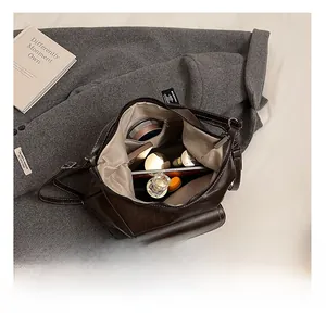 Detailed internal view of large capacity coffee faux leather backpack with multiple pockets