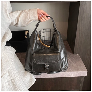 Detail of a vintage black hobo bag with contrast stitching and silver buckle accent