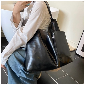 Macro detail of high-quality black faux leather texture on large capacity tote bag