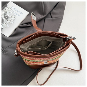 Detail view of woven bucket bag interior with striped fabric lining and inner zipper pocket